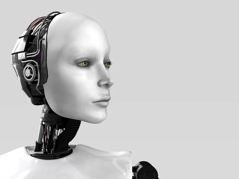 robotic female head with green eyes and intricate circuitry on a gray background