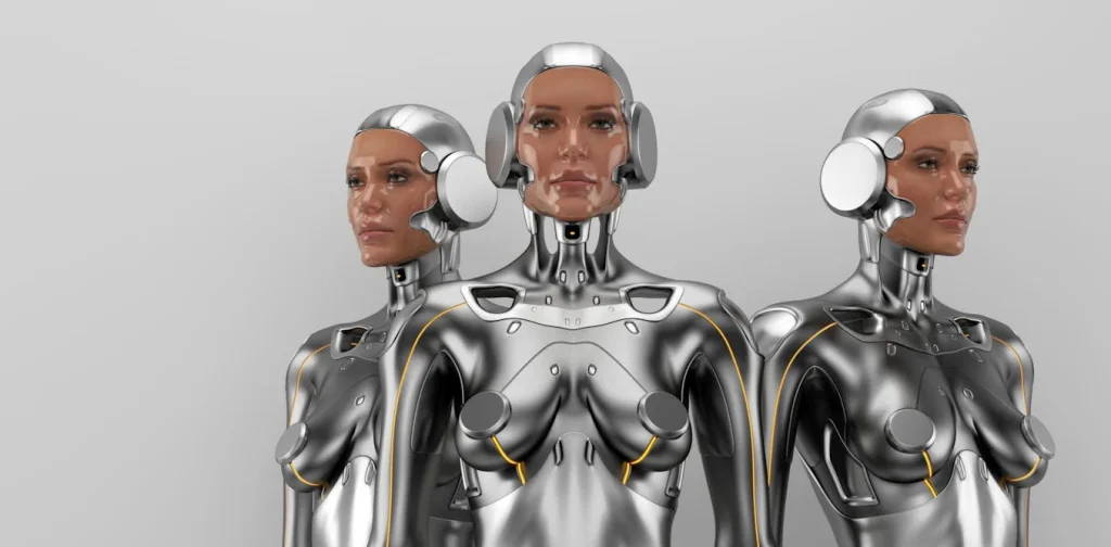 three humanoid robots with metallic bodies and realistic facial features, set against a plain background